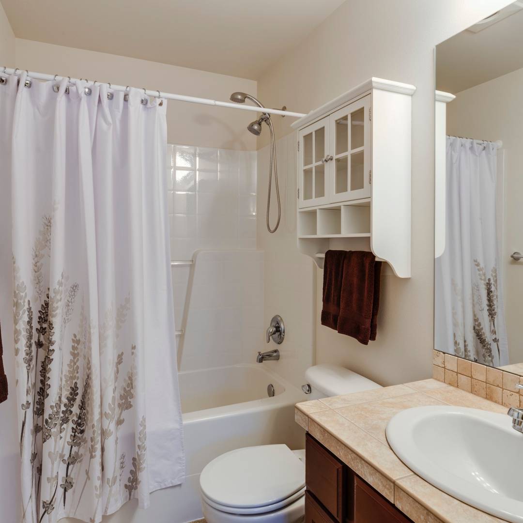 Replace the old shower curtain with a new, modern one